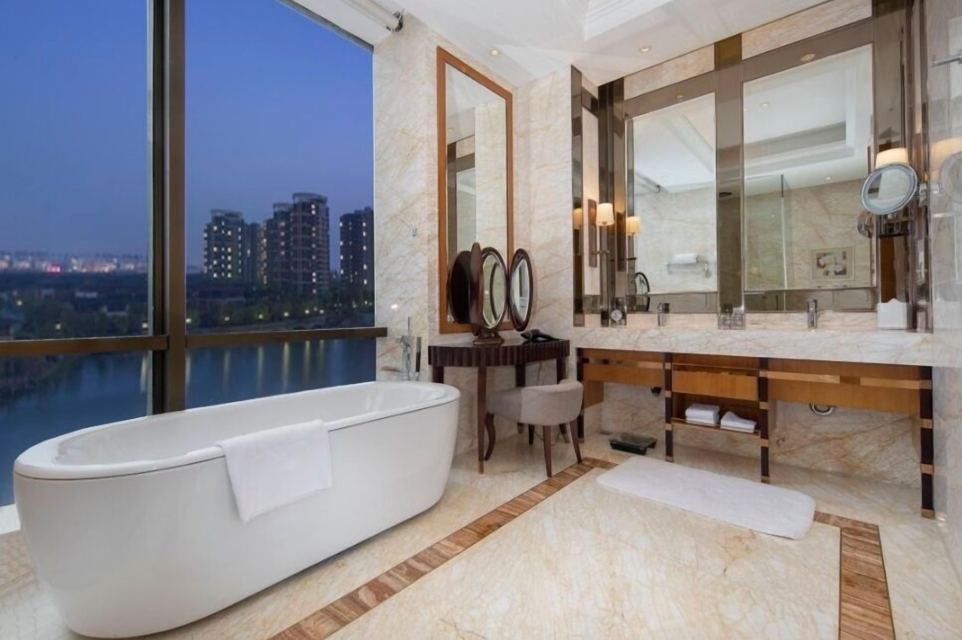 1 king junior suite lake view | bathroom | deep-soaking bathtub, rainfall showerhead, designer toiletries