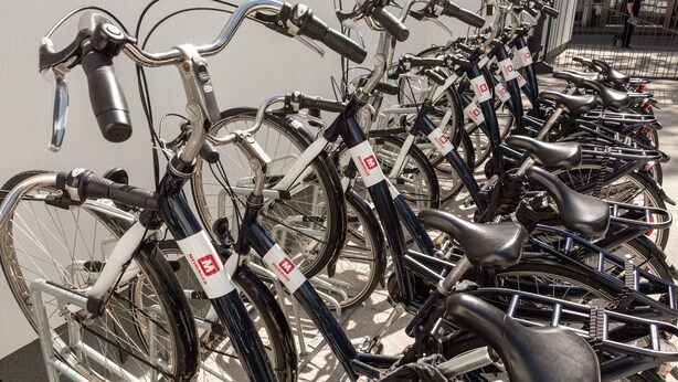 A row of bicycles parked in a bike rack. - Meininger (Brussels)
