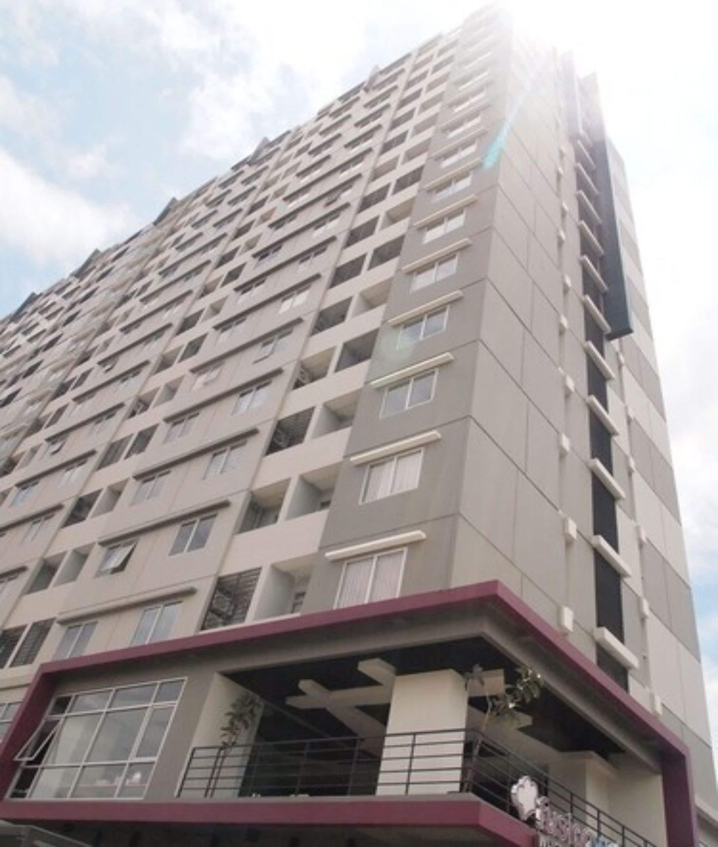 A high-rise building with multiple balconies and a modern architectural design.