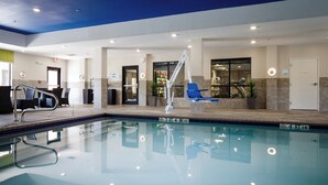 An indoor swimming pool with a lifeguard stand, lounge chairs, and a clear poolside area. - Holiday Inn Express Hotel & Suites El Reno by IHG (El Reno)