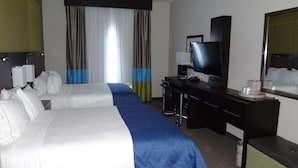A hotel room with two beds, a desk with a computer, a TV, and a large window with curtains. - Holiday Inn Express Hotel & Suites El Reno by IHG (El Reno)