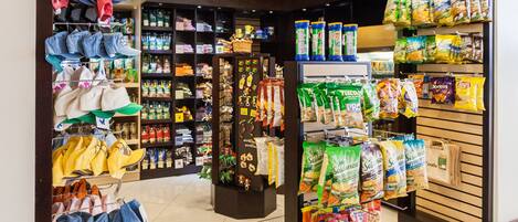 A store with shelves of snacks, hats, and other items.
