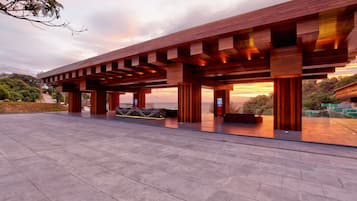 A modern building with a wooden exterior and a spacious covered area.