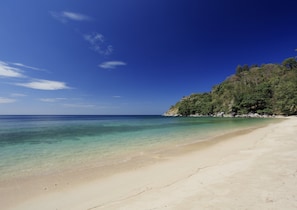 On the beach, white sand, sun-loungers, beach umbrellas - The Naka Phuket, a member of Design Hotels (Kamala)