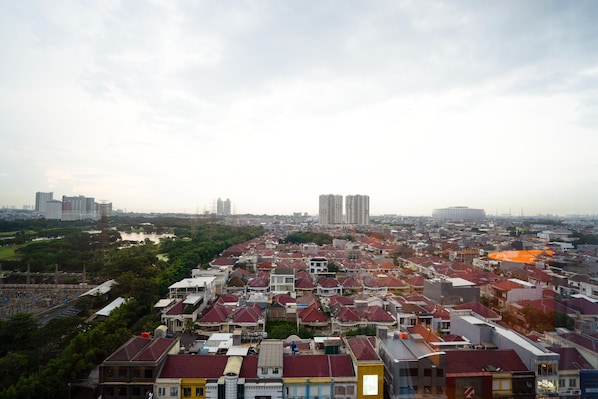 A densely packed urban area with a variety of building styles and a river in the background.