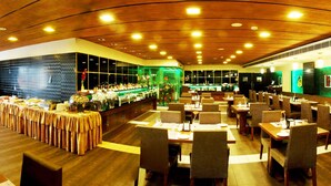 A restaurant with a buffet, multiple dining tables, and a bar area. - Olive Eva (Kanayannur)