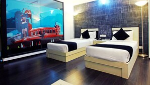 A hotel room with two beds, a large TV screen, and a modern design. - Olive Eva (Kanayannur)