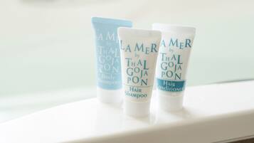 Three toiletry bottles labeled 'Lamer by Thai Goja' on a white surface.