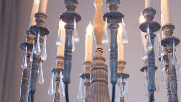 A chandelier with multiple candles and icicles.