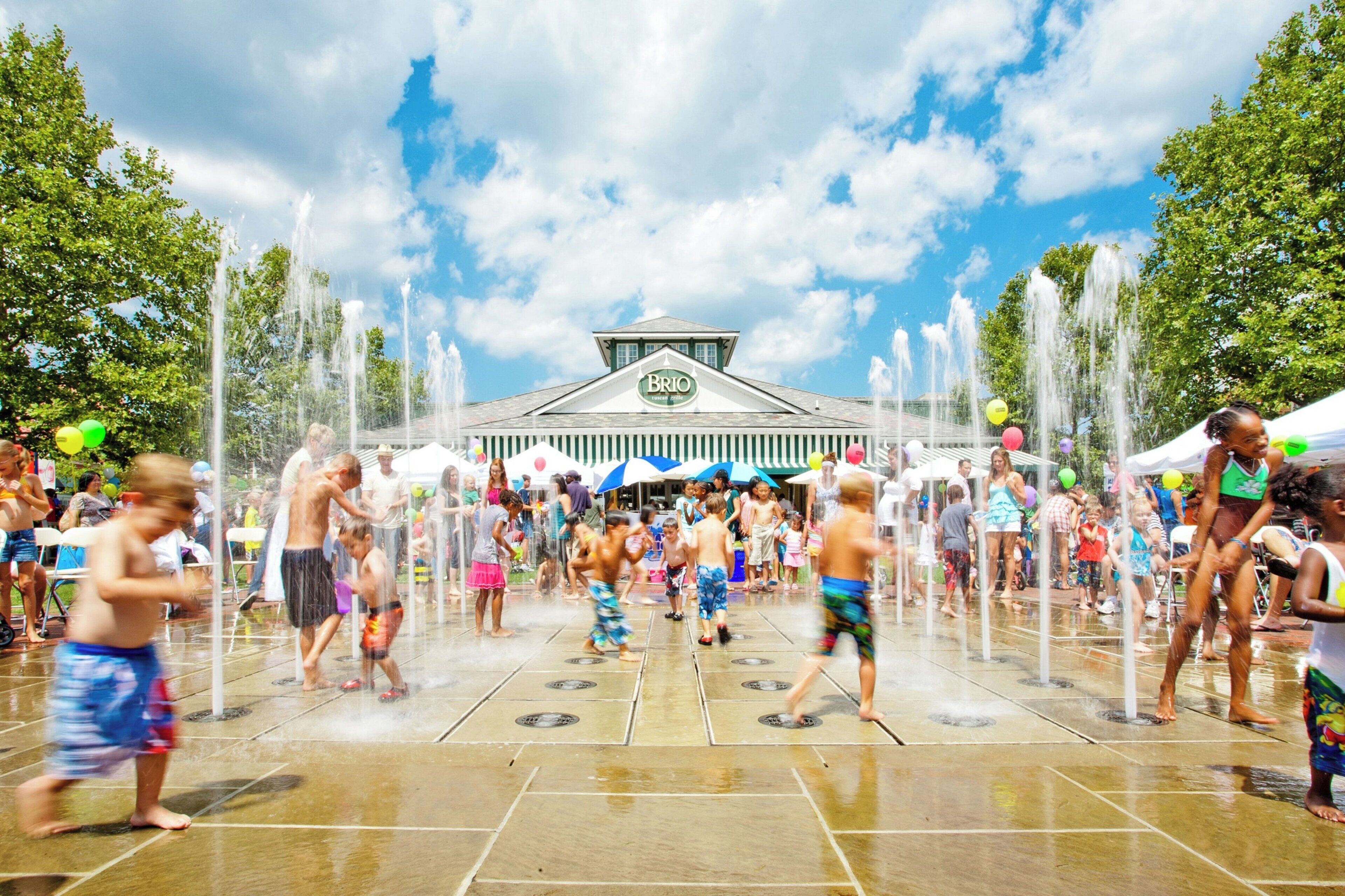 A water fountain area with a building in the background.