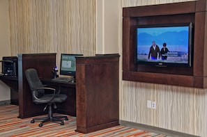 A hotel room with a desk, computer, and a television mounted on the wall. - Holiday Inn Express & Suites Columbus - Easton Area by IHG (Columbus)