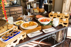A buffet table with various food items and serving dishes. - Burasari Heritage Luang Prabang (Luang Prabang)