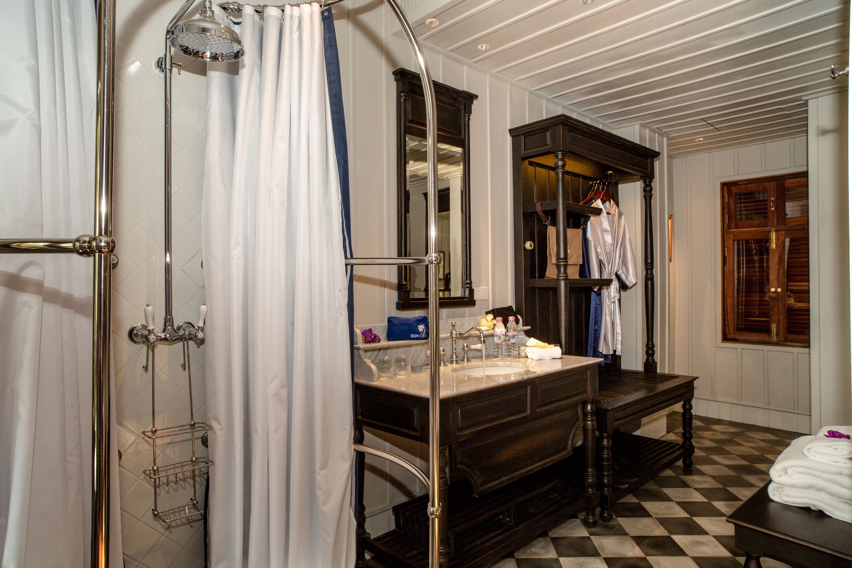 A bathroom with a shower, a sink, and a vanity.