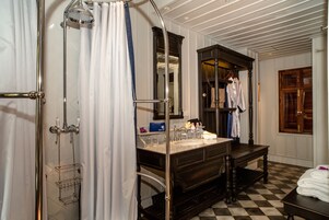 A bathroom with a shower, a sink, and a vanity.