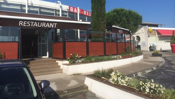A building with a 'BAR-RES' sign and a 'HOTEL' sign, indicating a restaurant and hotel establishment.
