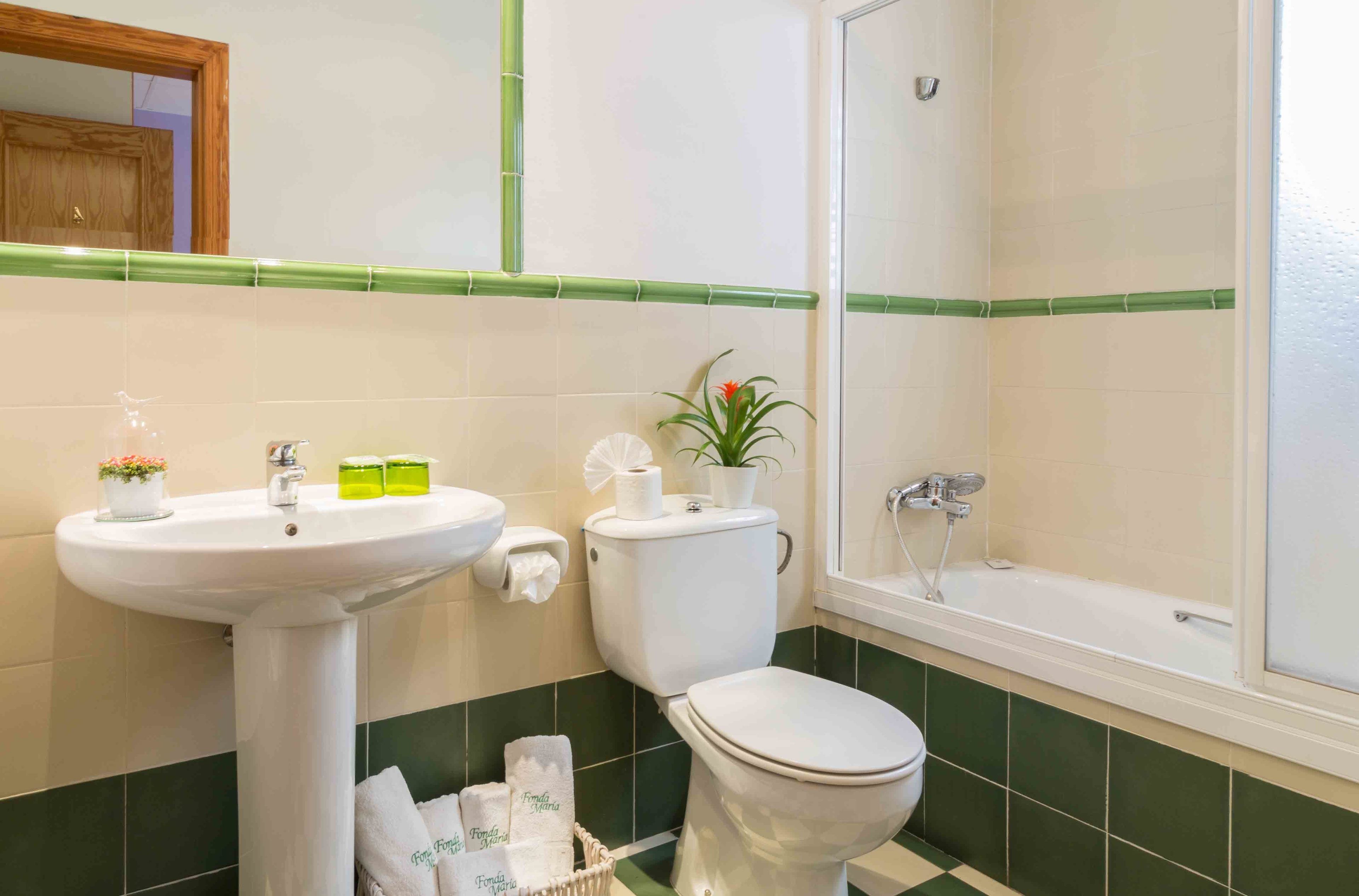 A bathroom with a sink, toilet, and bathtub.