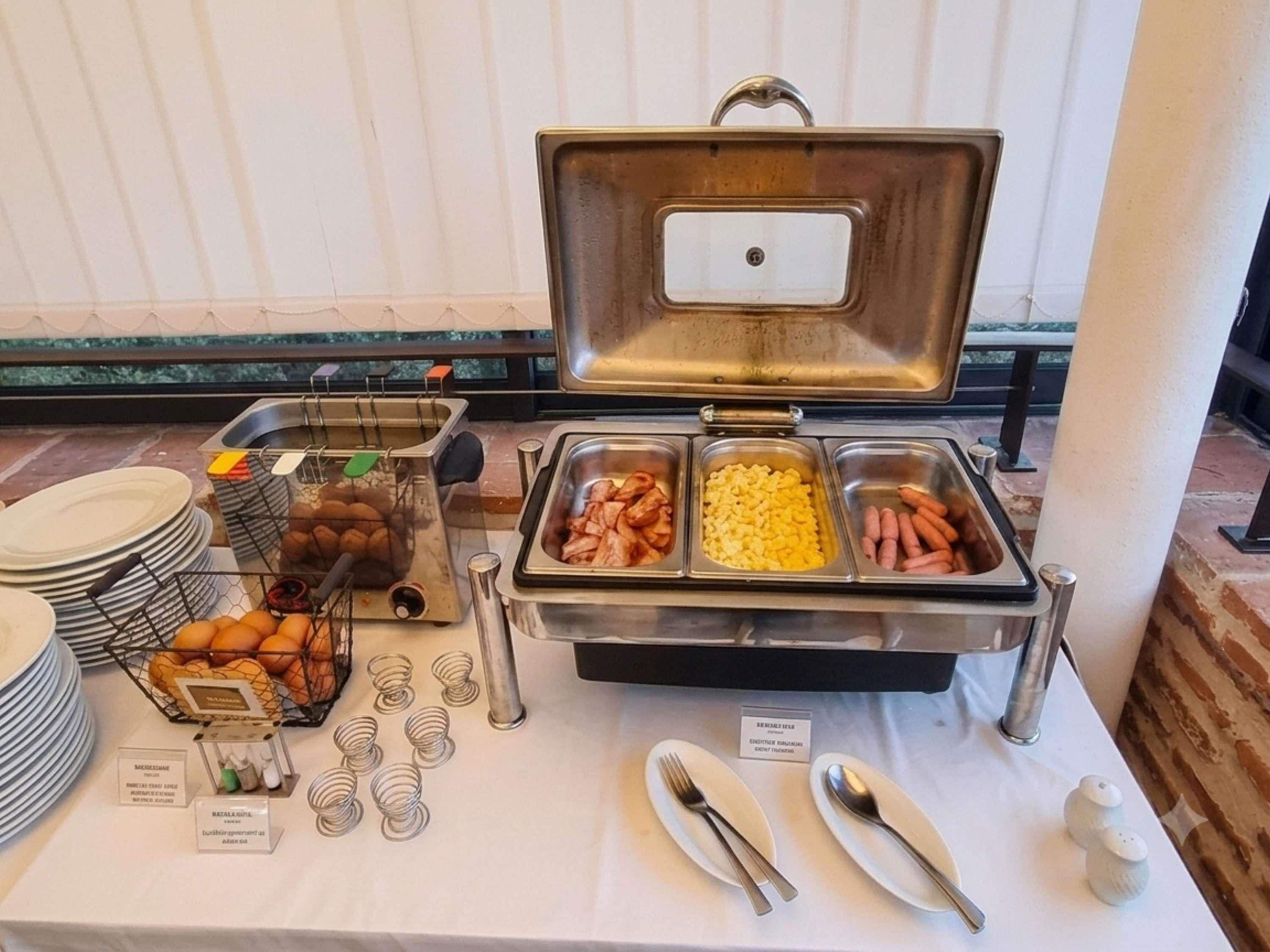 A buffet setup with various food items and utensils.