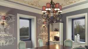 A dining room with a large table, chairs, a chandelier, and decorative wall panels. - Hôtel Mercure Villeneuve sur Lot Moulin de Madame (Villeneuve-sur-Lot)