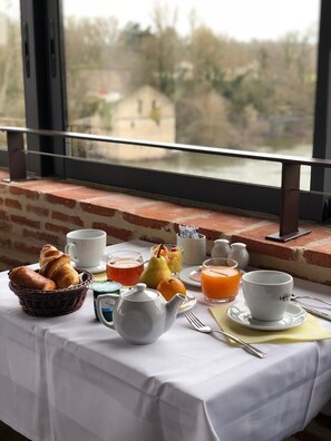 Enjoy a leisurely breakfast on the balcony with a view, surrounded by a delicious spread of pastries, fresh fruit, and savory ham.