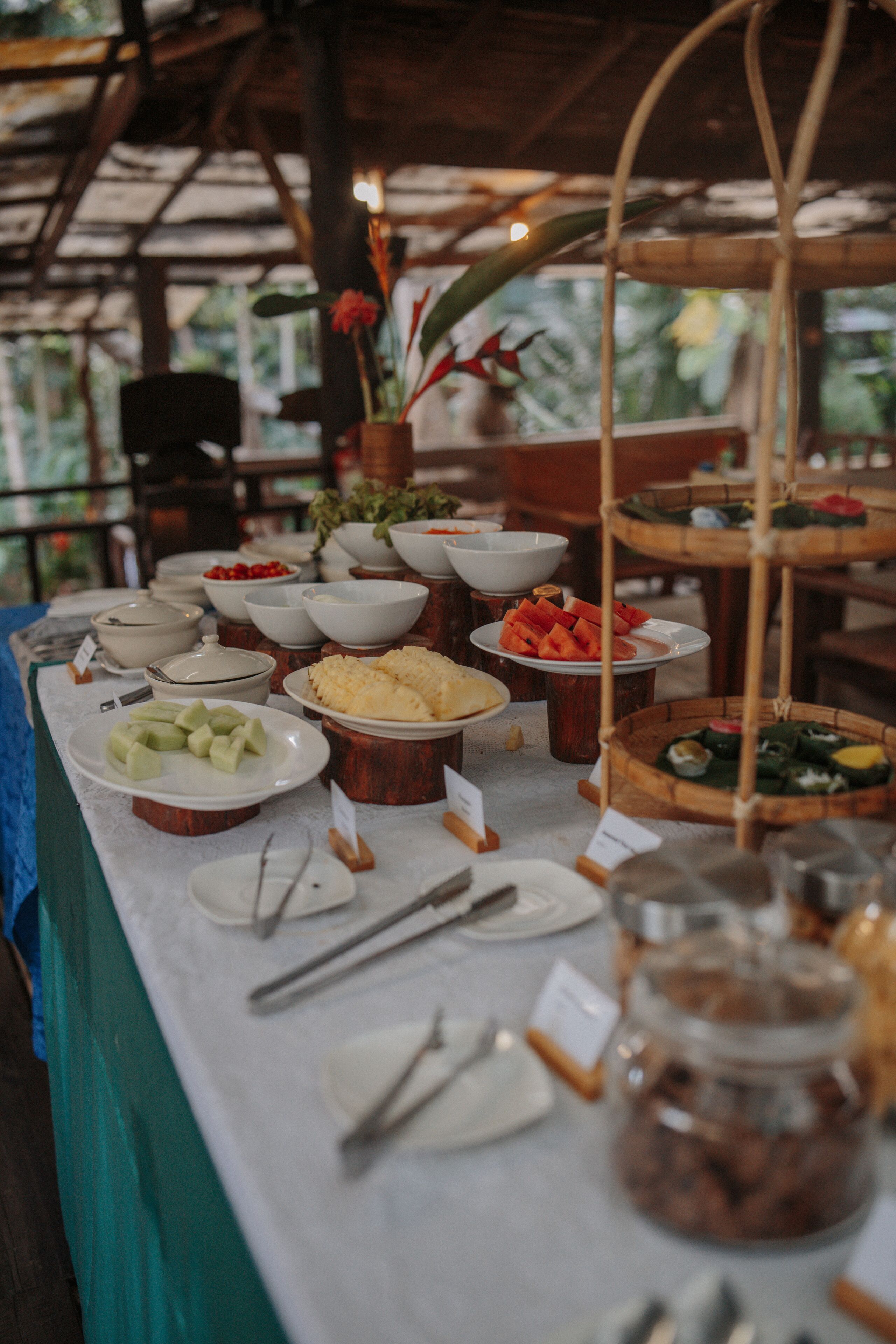 A buffet table with various food items and serving utensils.