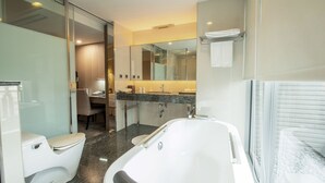 A modern bathroom with a bathtub, toilet, and vanity. - CHECK inn Select Taichung Dadun (Taichung)