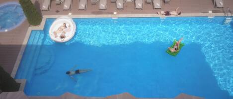 Una piscina amb gandules i ombrel·les.