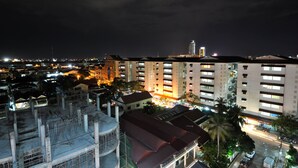 A high-rise building with multiple floors, a prominent tower, and surrounding infrastructure. - Jun Yue Hotel (Phnom Penh)