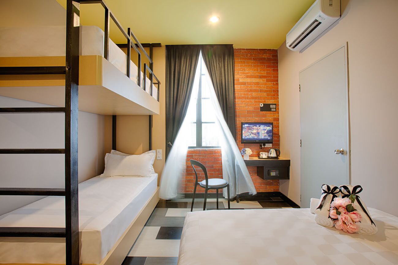 deluxe quadruple room | in-room safe, desk, blackout curtains, free wifi