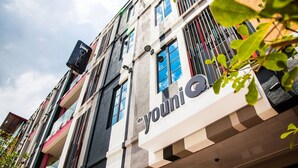 A multi-story building with the name "the youni" prominently displayed. - the youniQ Hotel (Sepang)