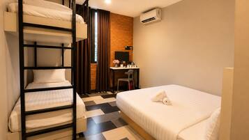 A bunk bed room with a desk, chair, and air conditioning unit.