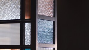 Un mur composé de plusieurs panneaux, chacun présentant des textures et des motifs différents.