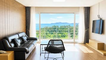 Luxury Suite, 2 Bedrooms, Hot Tub, Ocean View | Living area | 41-inch LCD TV with cable channels, TV, heated floors