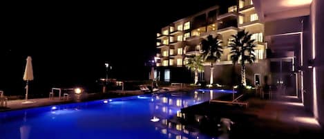 Seasonal outdoor pool, open 1:00 PM to 9:00 PM, pool umbrellas