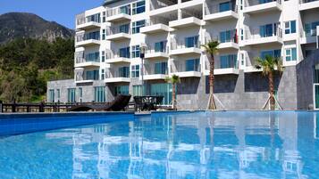 Seasonal outdoor pool, open 1:00 PM to 9:00 PM, pool umbrellas