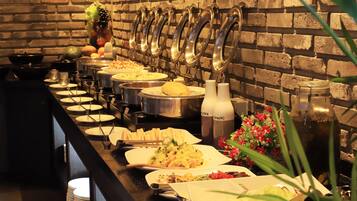 A buffet setup with various dishes and beverages.