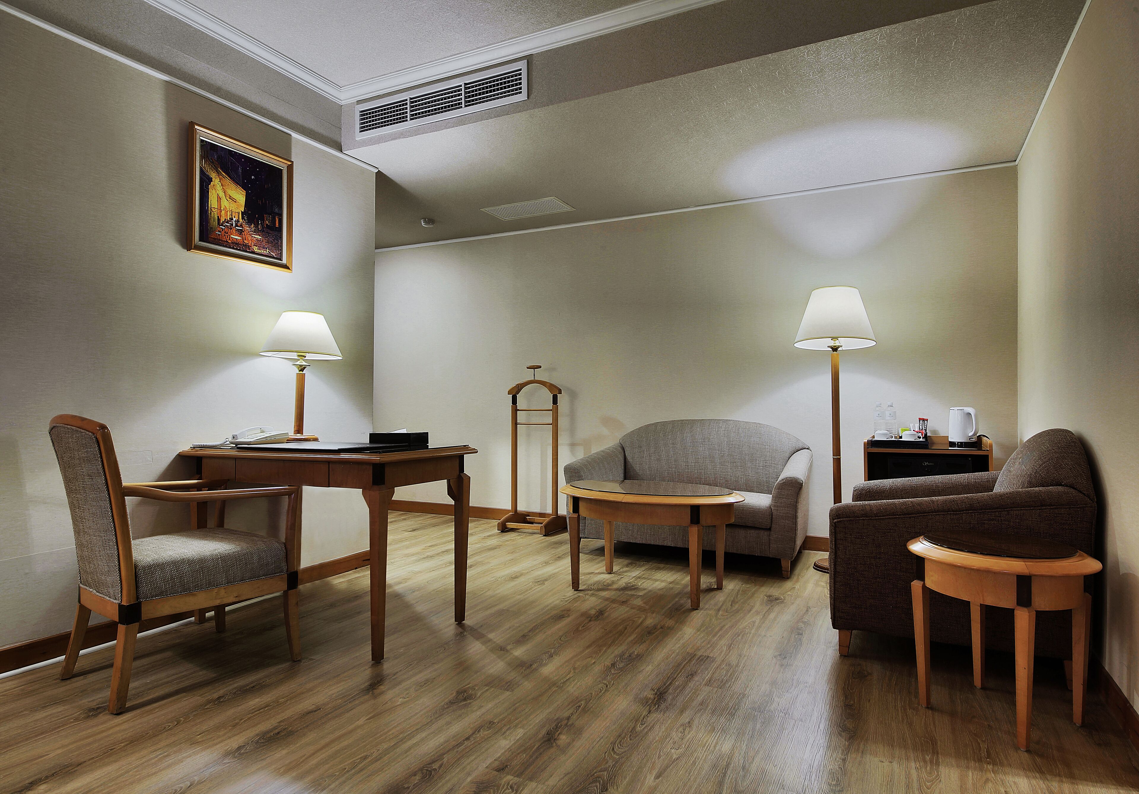 executive queen room (please read special check-in instruction before booking) | living area | 32-inch lcd tv with cable channels, tv, dvd player