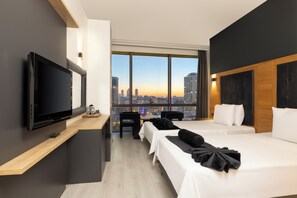 A modern hotel room with a large TV, a desk, two beds, a city view, and a wooden accent wall. - My Plus Royal Ataşehir (Istanbul)