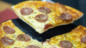 A pizza with pepperoni slices.