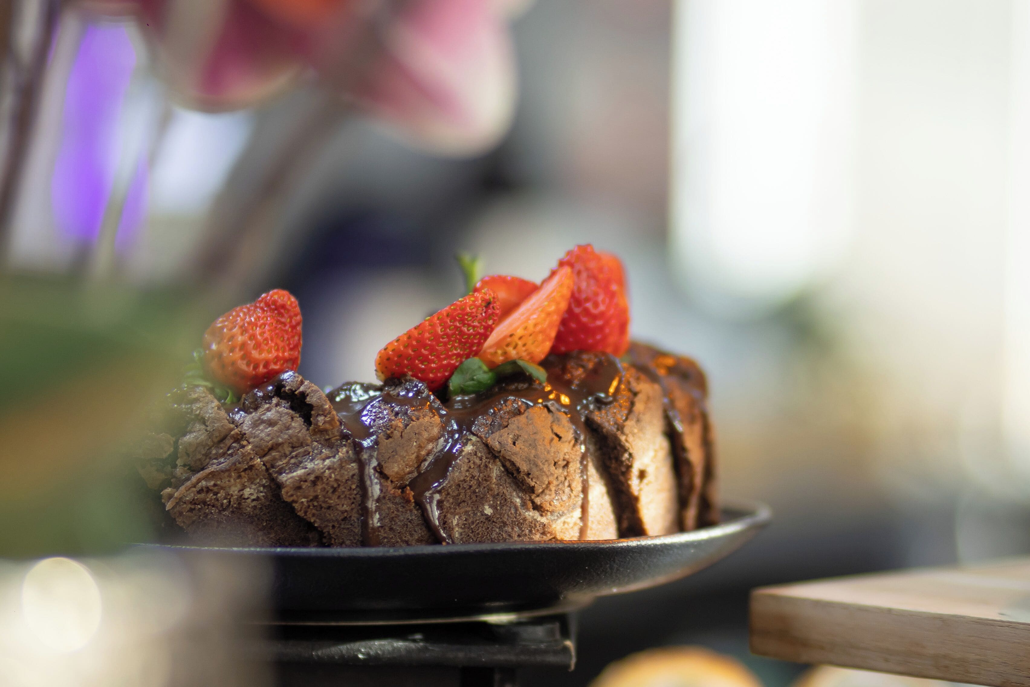 A dessert with strawberries and chocolate sauce on a plate.