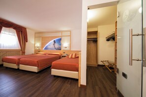 A hotel room with two beds, a wardrobe, and a mirror with a space-themed artwork. - Touring (Predazzo)
