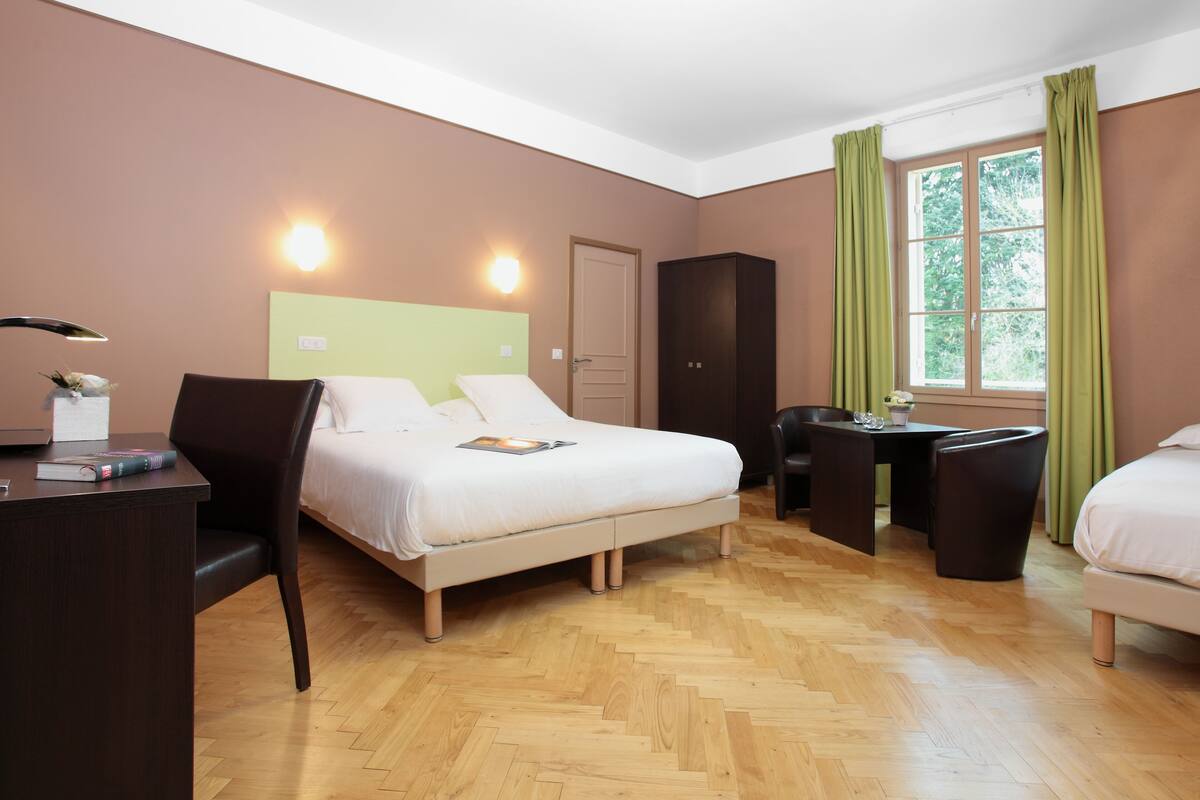 superior triple room | in-room safe, desk, laptop workspace, blackout curtains