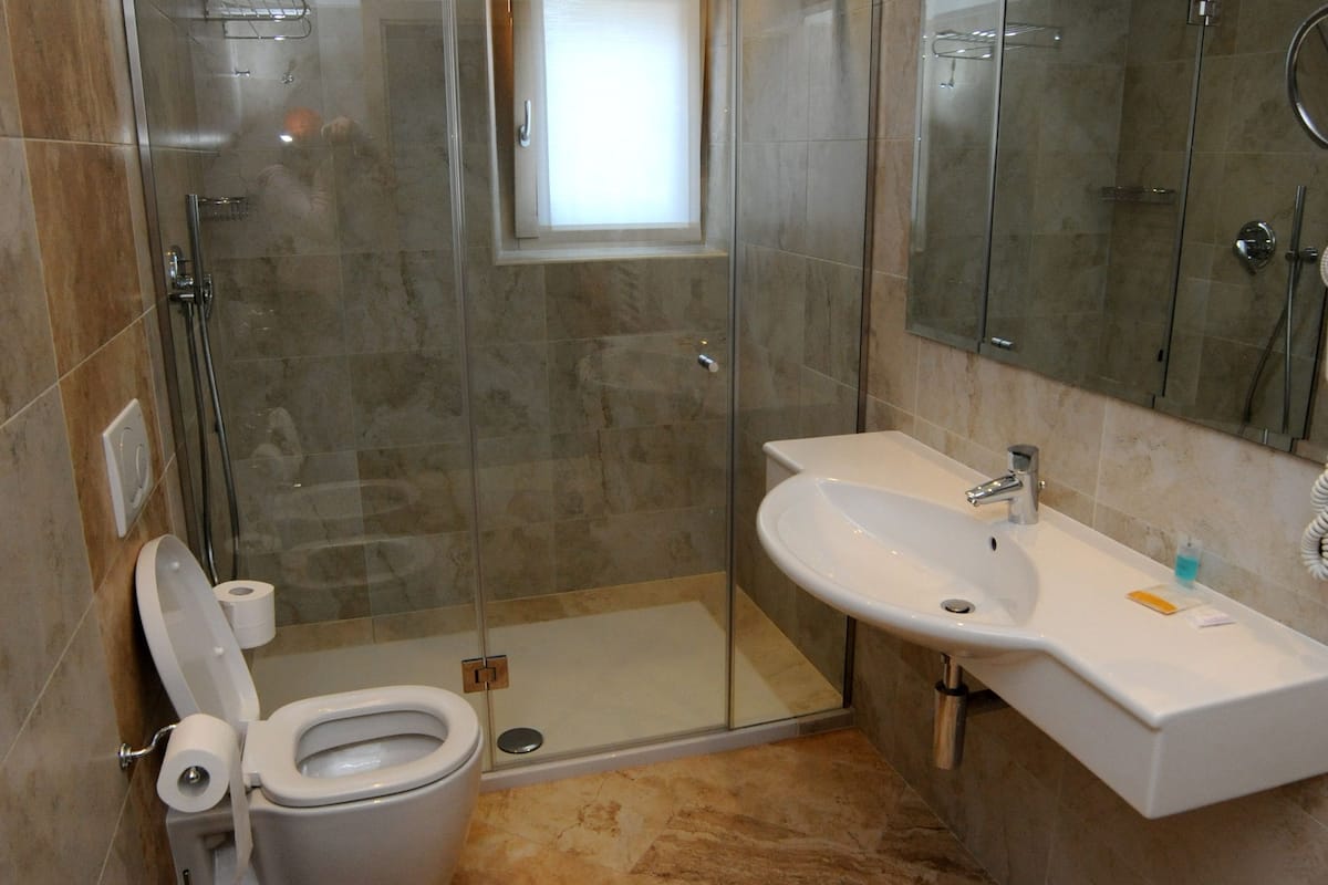 superior room | bathroom | shower, rainfall showerhead, hair dryer, bidet
