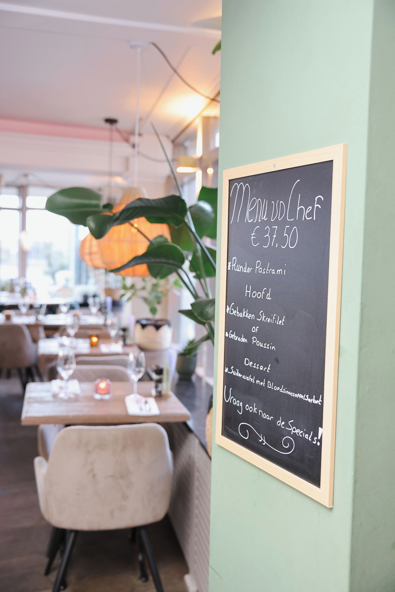 A chalkboard menu in a restaurant with a price of €37.50.