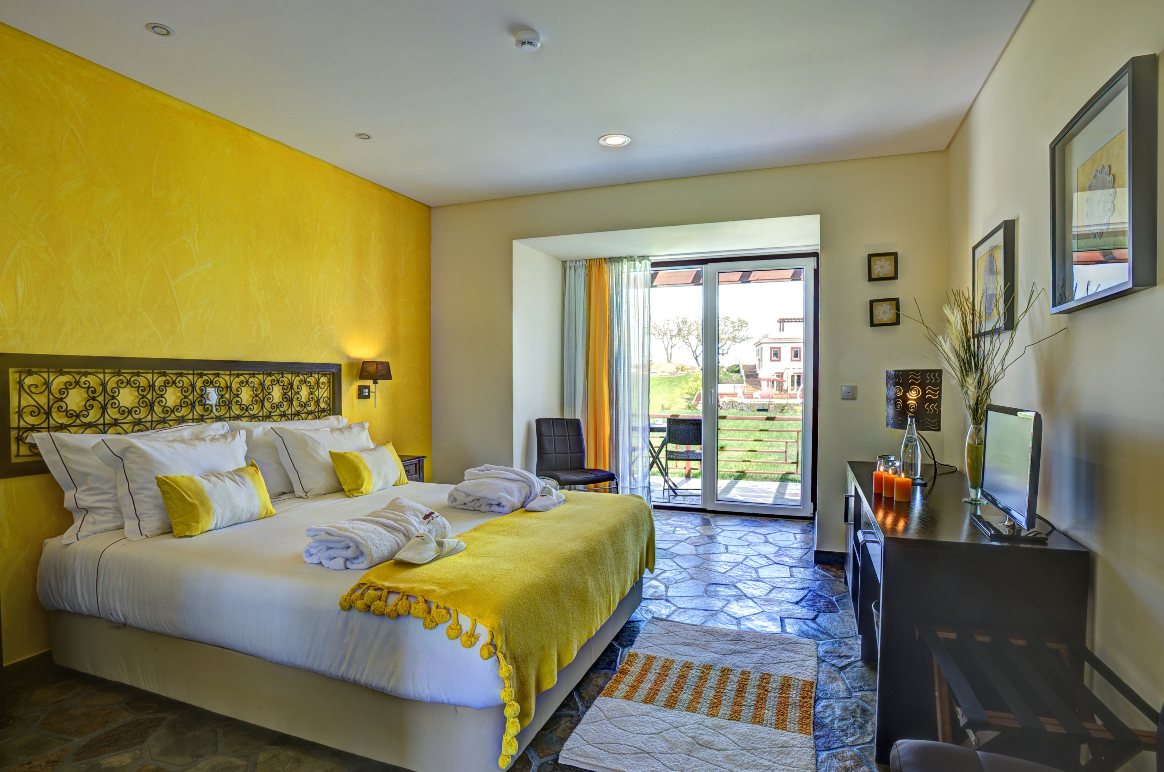 Una habitación de hotel con cama, escritorio y vistas al exterior.