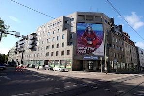 A multi-story building with a large billboard advertising a hotel. - Center Hotel (Tallinn)