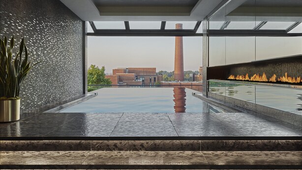 Ein moderner Innenpool mit Glasdecke, Feuerstelle und Blick auf ein weit entferntes Gebäude.