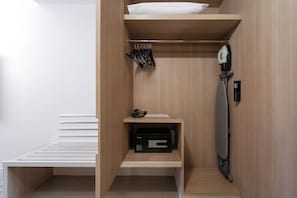 A compact, modern bathroom with a wooden vanity, a towel rack, and a built-in hairdryer. - Mercure Bangkok Siam (Bangkok)