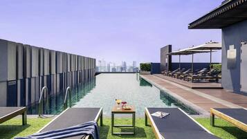 Outdoor pool, open 7:00 AM to 10:00 PM, pool umbrellas, sun loungers