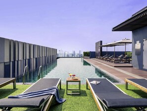 Outdoor pool, open 7:00 AM to 10:00 PM, pool umbrellas, pool loungers