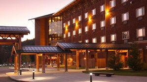 A multi-story hotel with a modern architectural design, featuring a large glass facade and a covered entrance area. - Little Creek Casino Resort (Shelton)